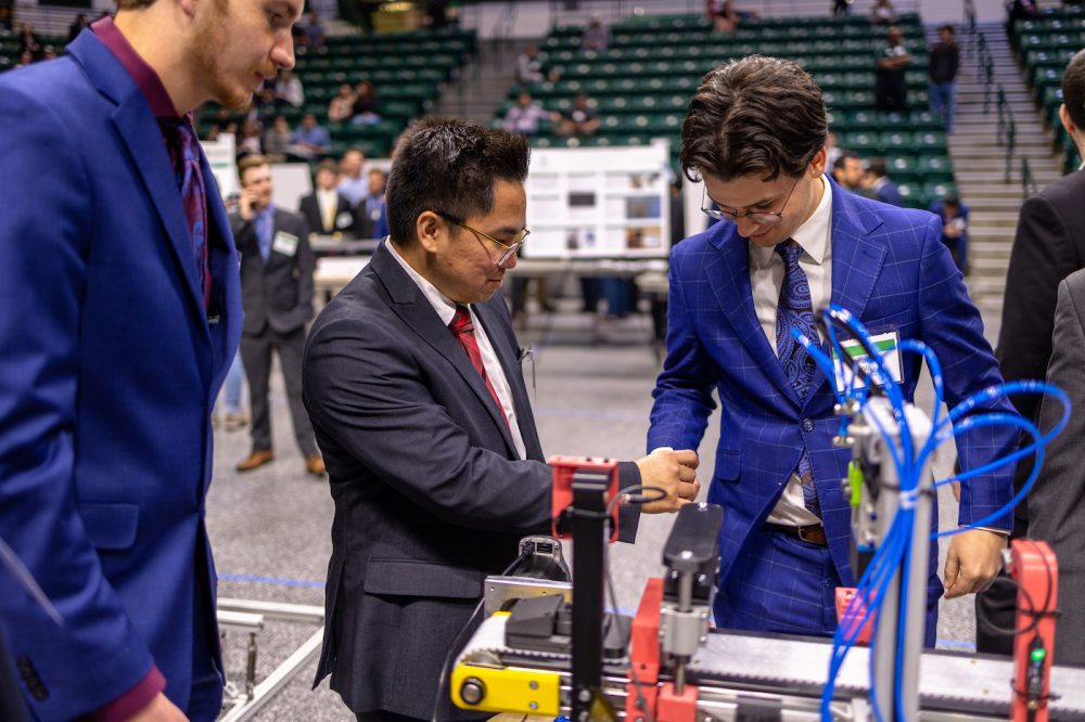 Senior engineering students demonstrate how project works during the Senior Design Expo