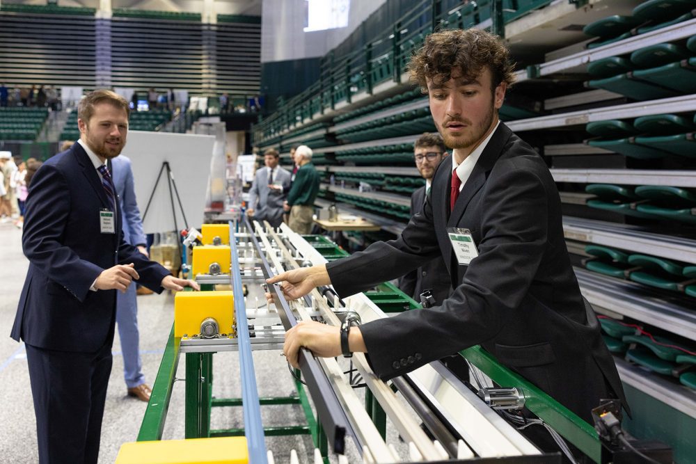 Senior engineering students demonstrate how project works during the Senior Design Expo