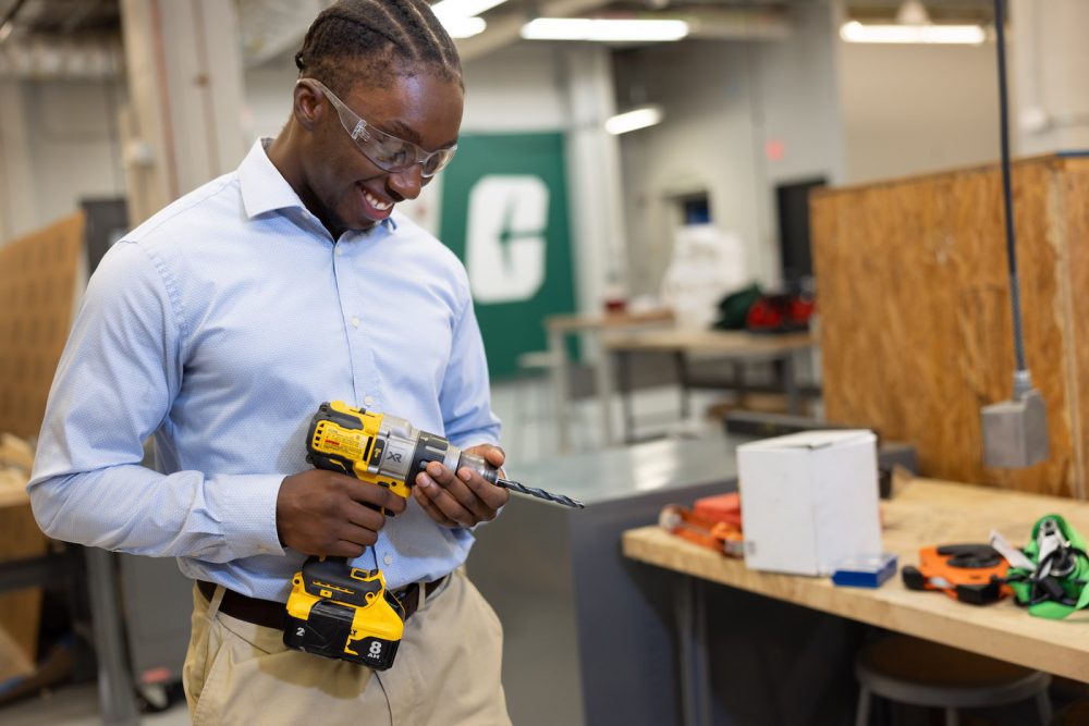 Student working with power tool in Industrial Solutions Lab